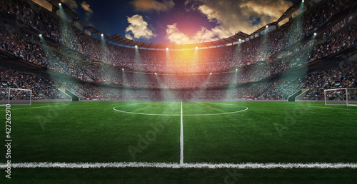 Football lies in the smoke on stadium grass