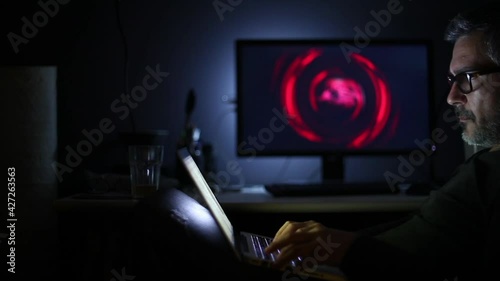 Man With Glasses Working on Computer Or Tablet
