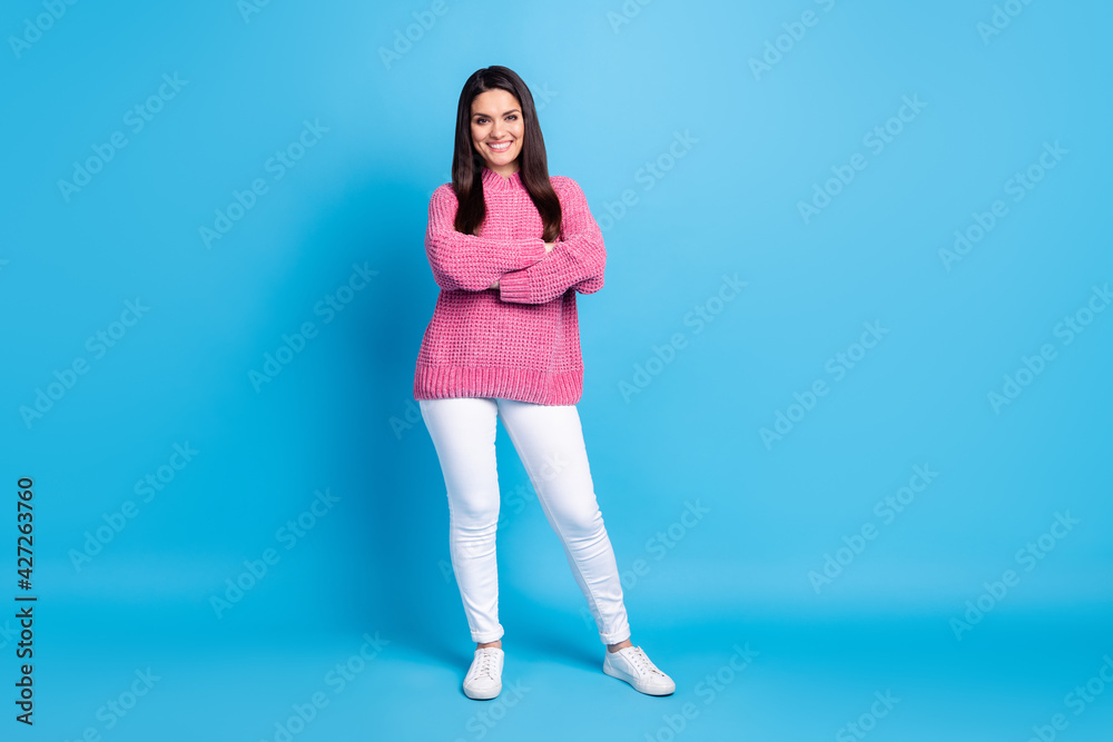 Photo of charming confident mature woman wear pink pullover standing arms crossed isolated blue color background Photo of charming confident mature woman wear pink pullover standing arms crossed isolated blue color background