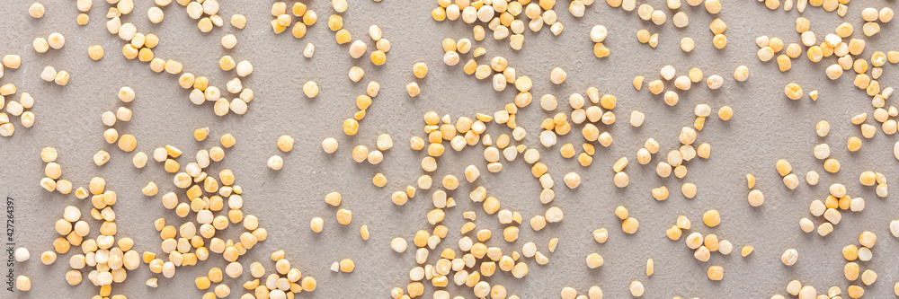Legumes are scattered in the background, natural banner of yellow peas, top view Legumes are scattered in the background, natural banner of yellow peas, top view