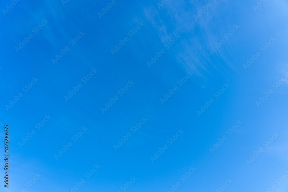 Blue morning sky with small clouds, calm scene