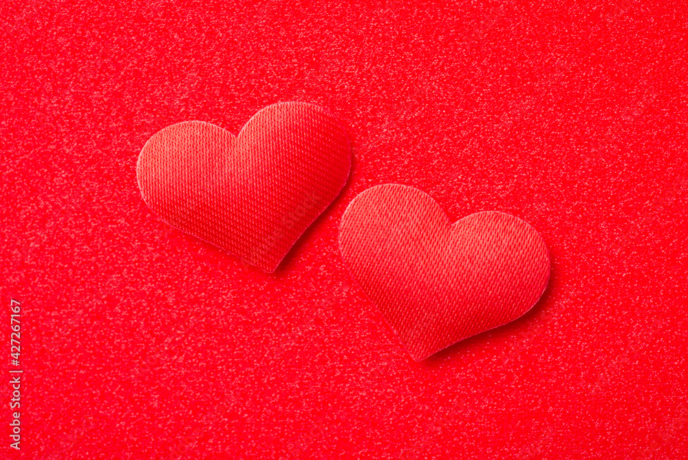 Top view of two red decorative hearts on red background. Passion, love, strong emotions concept. Top view of two red decorative hearts on red background. Passion, love, strong emotions concept.