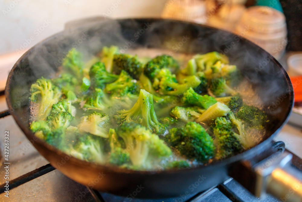 broccoli stew in a cast iron pan close-up broccoli stew in a cast iron pan close-up