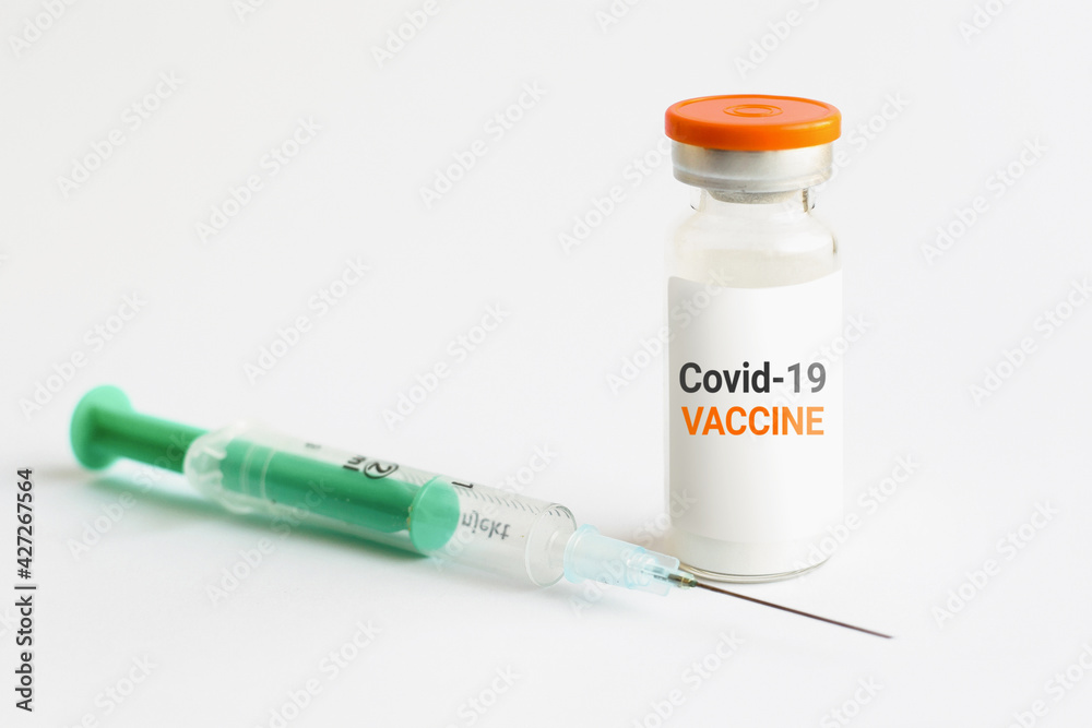 Coronavirus vaccine concept. Ampoules with text and syringe on a white background Coronavirus vaccine concept. Ampoules with text and syringe on a white background