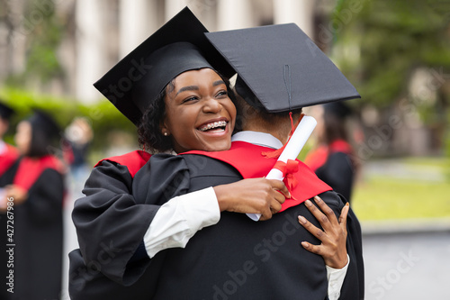 Εκτύπωση καμβά Happy african american couple students hugging, closeup