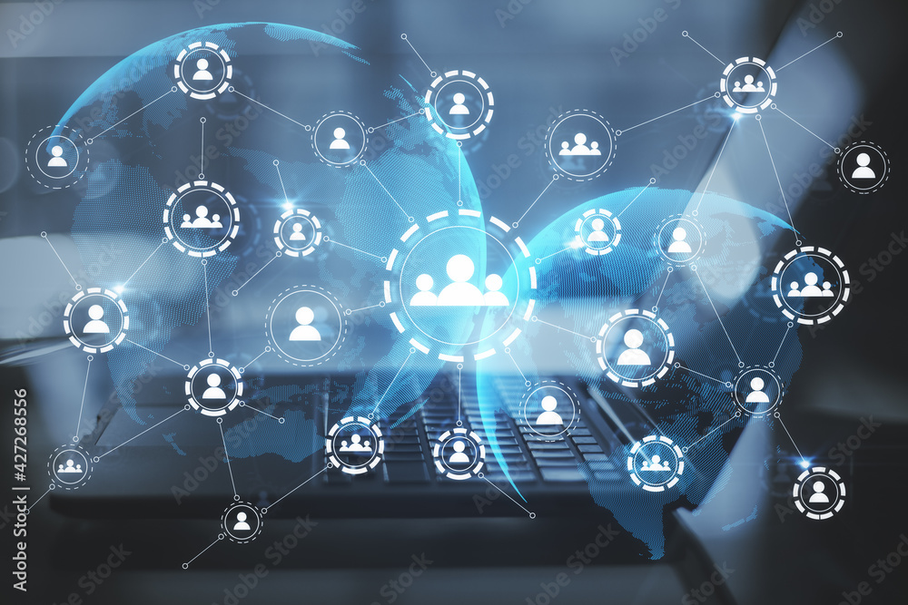 Social networking concept with glowing digital social media symbols with Earth planet silhouettes on abstract opened laptop background Social networking concept with glowing digital social media symbols with Earth planet silhouettes on abstract opened laptop background