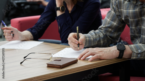 Obraz na płótnie Adult man and woman fill out paperwork or forms
