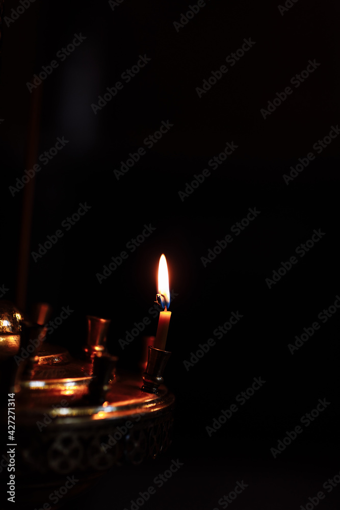 closeup of burning candle isolated on black background. closeup of burning candle isolated on black background.