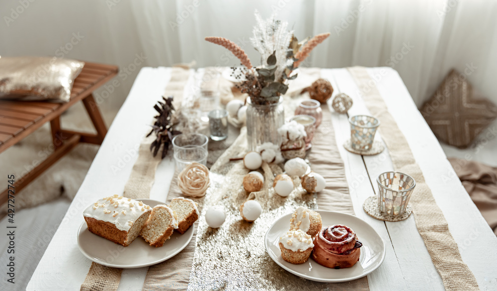 Fototapeta premium Festive table for Easter with decor details and homemade cakes.
