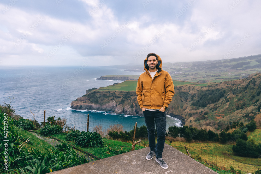 Naklejka premium Tourists are standing on a lookout platform with a beautiful view of the Azores - Portugal.