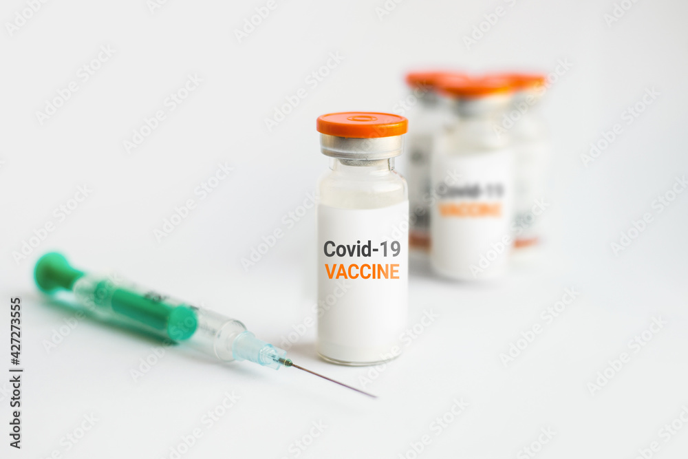 Coronavirus vaccine close up. Ampoules and syringe on a white background
