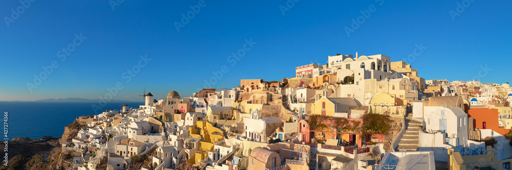 Fototapeta premium Sunset over Santorini island in Greece. Traditional church, apar