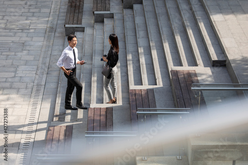 Young business people talking outdoors photo