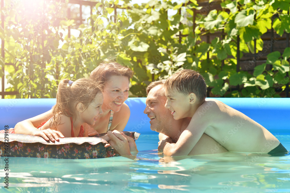 Happy family having fun in pool