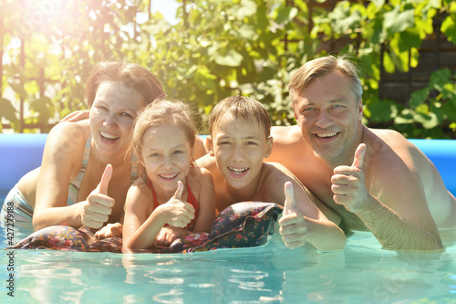 Happy family having fun in pool