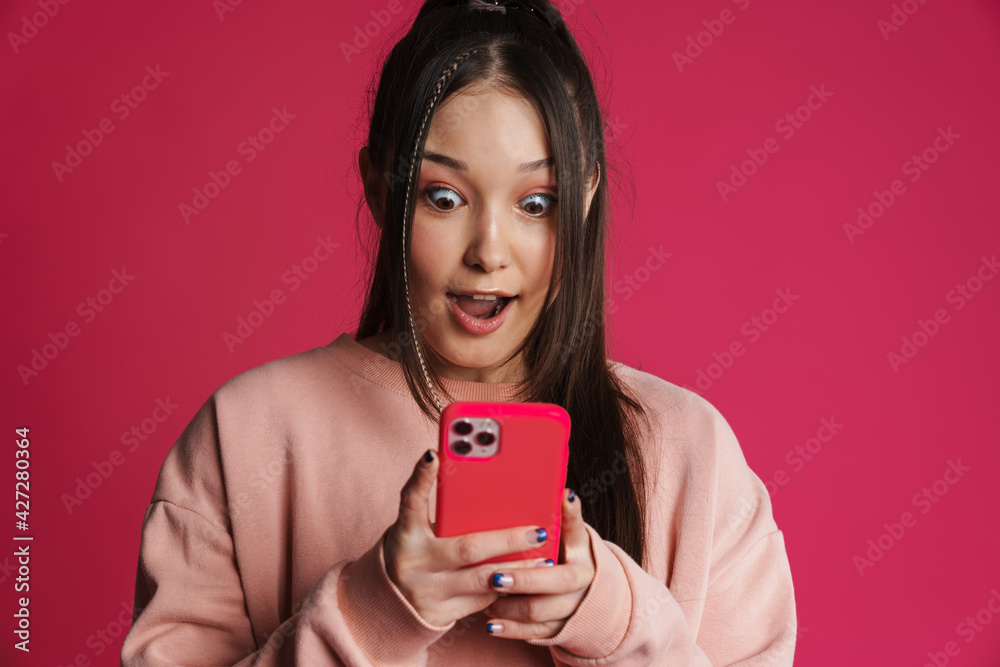 Asian brunette shocked woman using mobile phone Asian brunette shocked woman using mobile phone