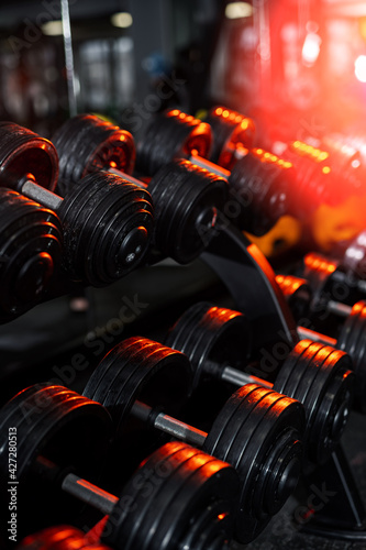 Rows of dumbbells in the gym. Modern gym photo