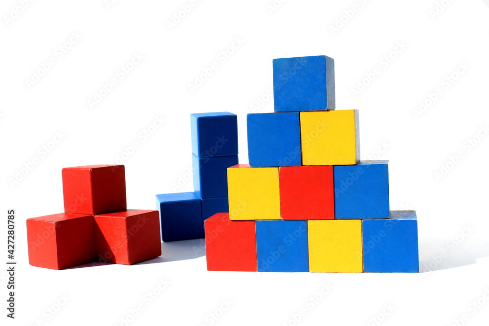 Children's toy. Bright multi-colored cubes are stacked in a pyramid. Children's toy. Bright multi-colored cubes are stacked in a pyramid.