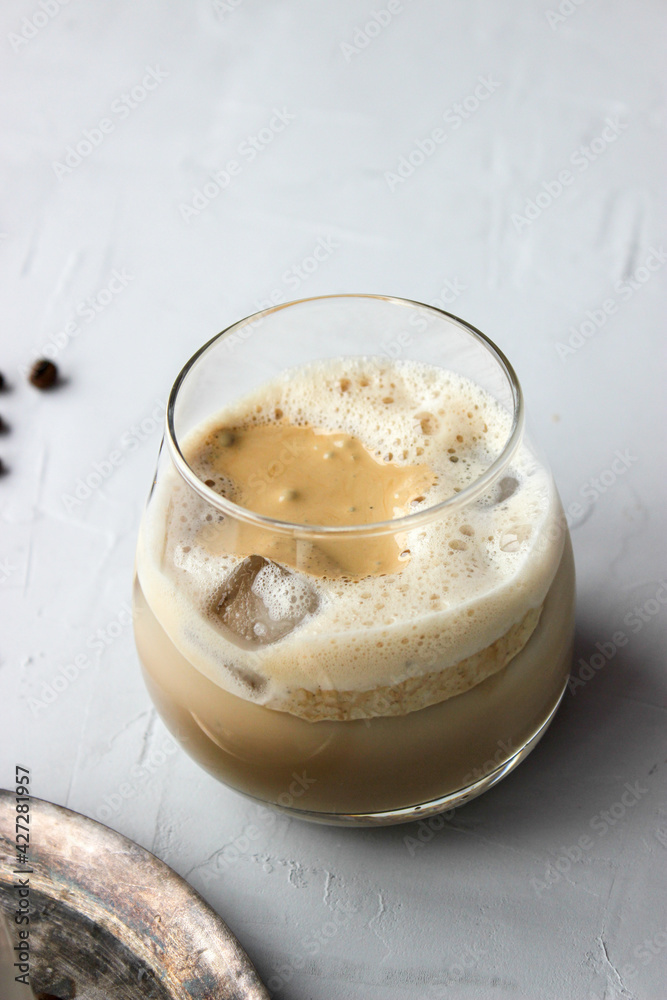 Cold coffee with foam and sweet straw
