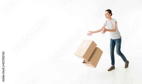 Clumsy woman dropping box stack