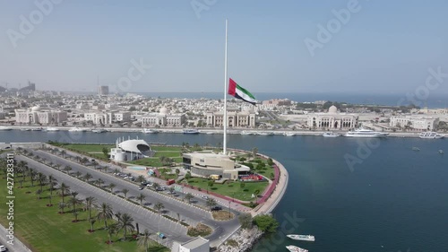 UAE Flag half-mast over Sharjah's Flag Island, United Arab Emirates. 4K  photo