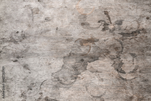 The texture of a wooden table with spots. Grey wood and round stains from drinks glasses. Texture background.