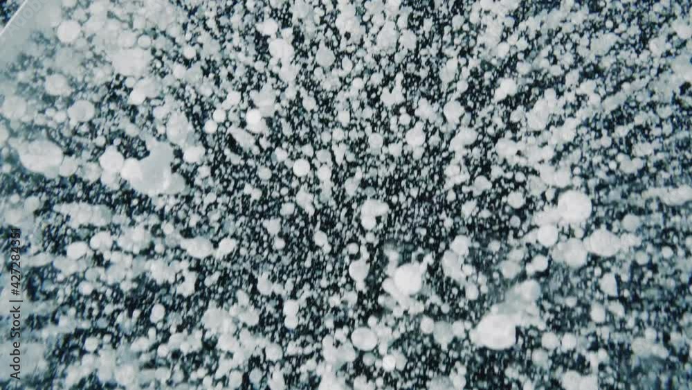 Methane Bubbles in Ice at Baikal Lake in Russia in Winter Methane Bubbles in Ice at Baikal Lake in Russia in Winter