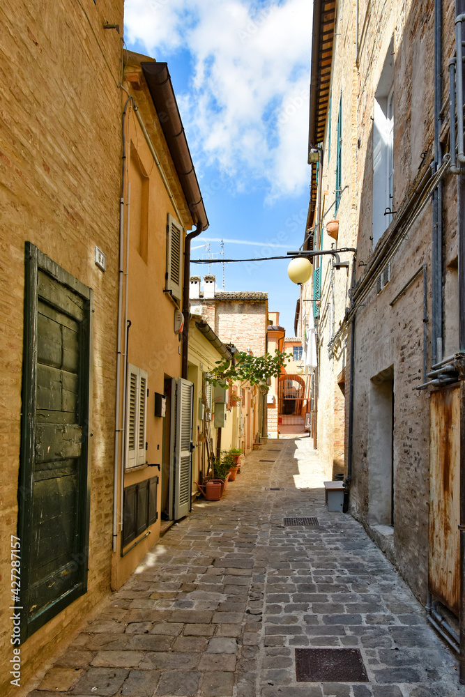 A narrow street between the old buildings of Macerata, a medieval town in the Marche region.