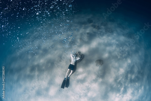 Free diver make bubbles in sea. Sporty man freediver in sea