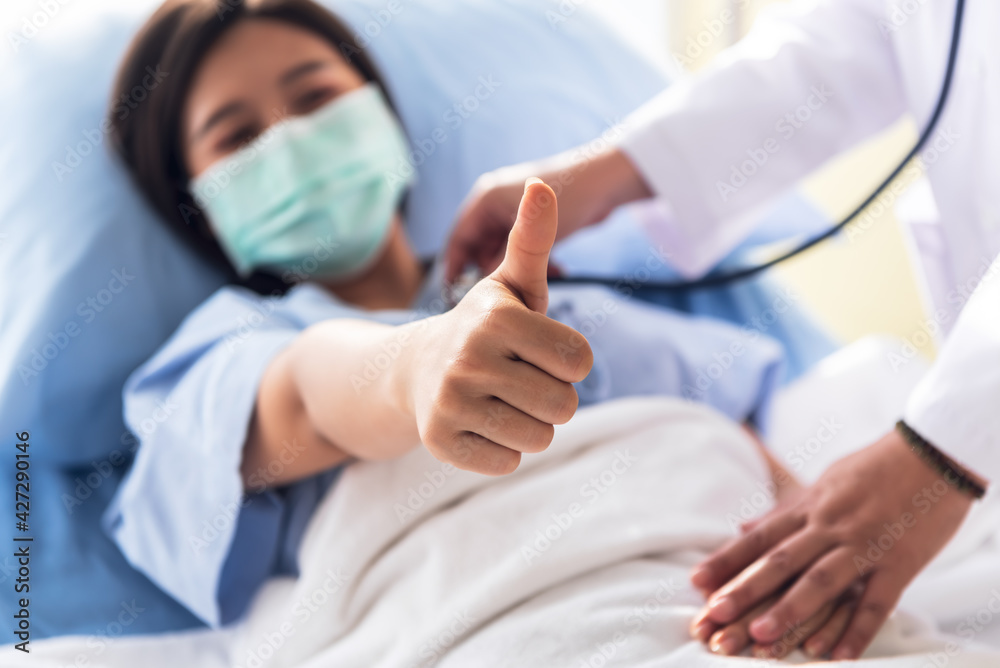 Blurred soft images of Doctor Using stethoscope physical examination and woman patients Raise they hand to make a great symbol, because of successful treatment, to health care and insurance concept. Blurred soft images of Doctor Using stethoscope physical examination and woman patients Raise they hand to make a great symbol, because of successful treatment, to health care and insurance concept.