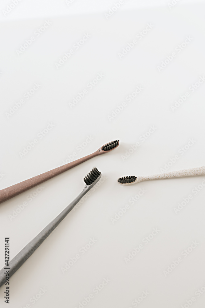 Set of biodegradable natural bamboo eco-friendly toothbrushes on white background. Top view, flat lay. Copy space. Zero waste, Dental care plastic free concept. Set of biodegradable natural bamboo eco-friendly toothbrushes on white background. Top view, flat lay. Copy space. Zero waste, Dental care plastic free concept.