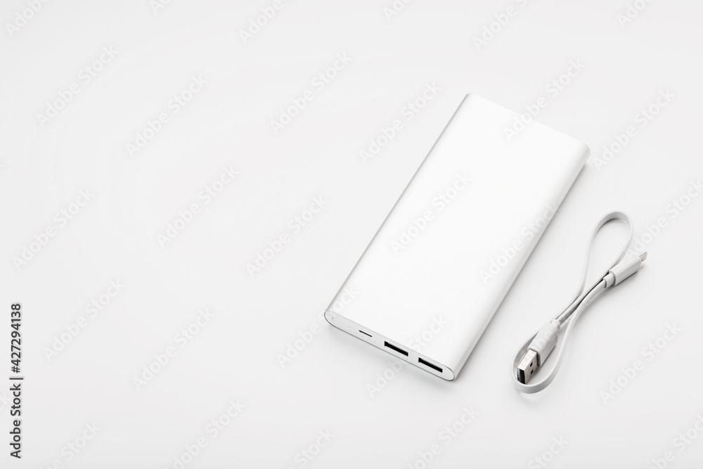 Powerbank for charging mobile devices with cable, on a white background. Powerbank for charging mobile devices with cable, on a white background.