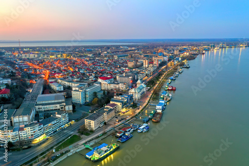 Galati, ROMANIA - March 19, 2021: Aerial view of Galati City, Romania. Danube River near city with sunset warm light