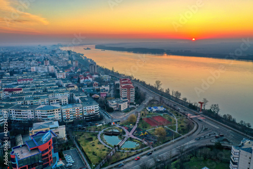 Galati, ROMANIA - March 19, 2021: Aerial view of Galati City, Romania. Danube River near city with sunrise warm light
