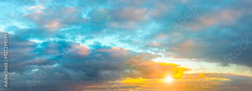 Beautiful panorama of the evening dramatic sky. Sunset or sunrise time. Amazing purple clouds.