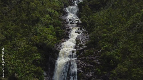 Aerial zoom out from majestic Colnett waterfall near Hienghene, revealing landscape over the east coast of New Caledonia photo