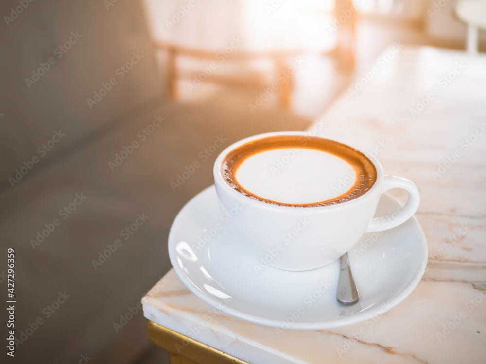 Side top view of hot coffee Cappuccino, espresso in the white cup put on the marble table in cafe morning work day background. Side top view of hot coffee Cappuccino, espresso in the white cup put on the marble table in cafe morning work day background.