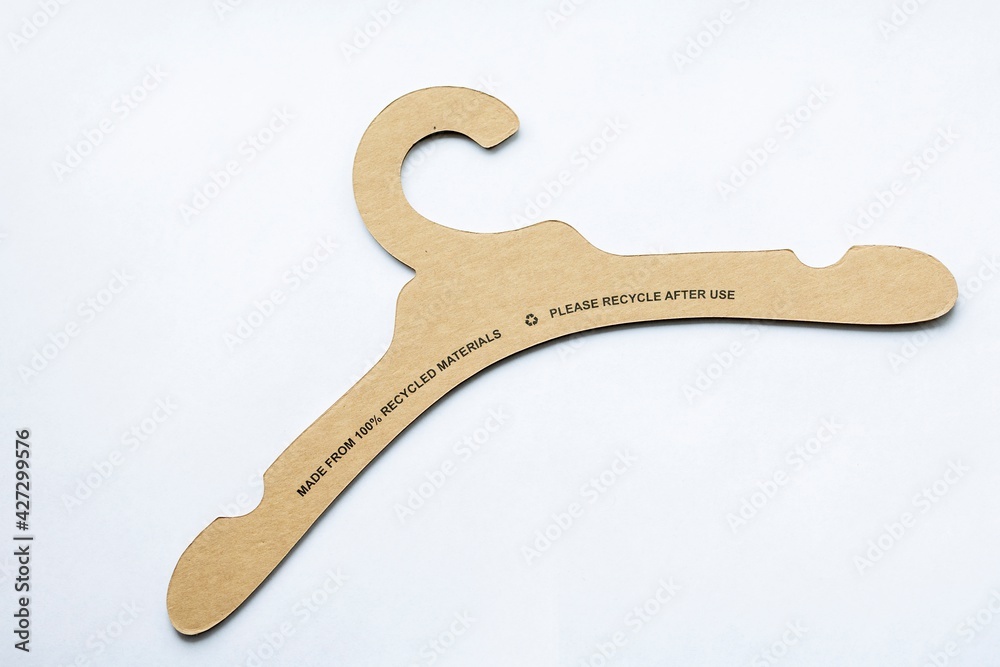 A portrait of a recyclable clothes hanger made of cardboard lying on a