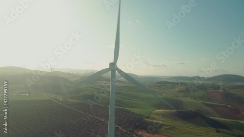 Drone moving around a wind turbine at the countryside photo