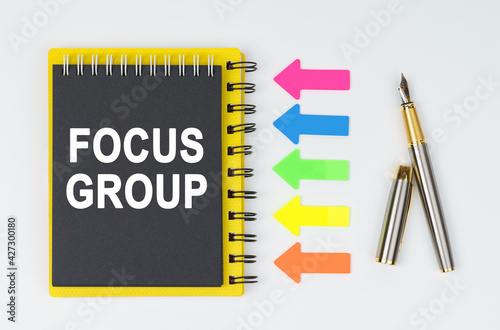 Wallpaper Mural On a white background lies a pen, arrows and a notebook with the inscription - FOCUS GROUP Torontodigital.ca