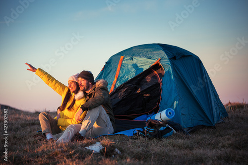 Couple at camping enjoying in sunset