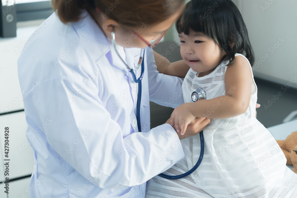 Asian doctor using a stethoscope to check his breathing and heart of a lovely girl, check the health of children,Thailand people Asian doctor using a stethoscope to check his breathing and heart of a lovely girl, check the health of children,Thailand people