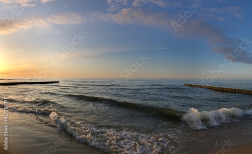 Panoramic view of bright sunset at Baltic sea in summer day