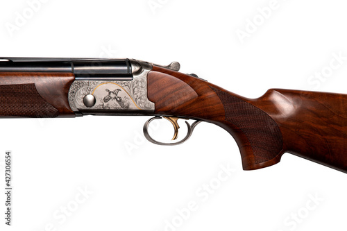Expensive classic double-barreled smooth-bore hunting rifle with engraving on a white background, close-up engraving