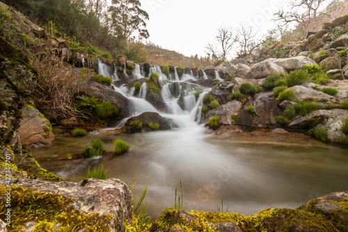 Long exposure of a small waterfall inserted in a pedestrian path in the village of Tondela, Portugal