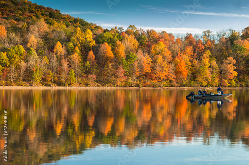 reflection of vibrant colorful peak autumn foliage of trees in the  serene Lake Habeeb in Rocky Gap State Park in Western Maryland Allegany county. photo