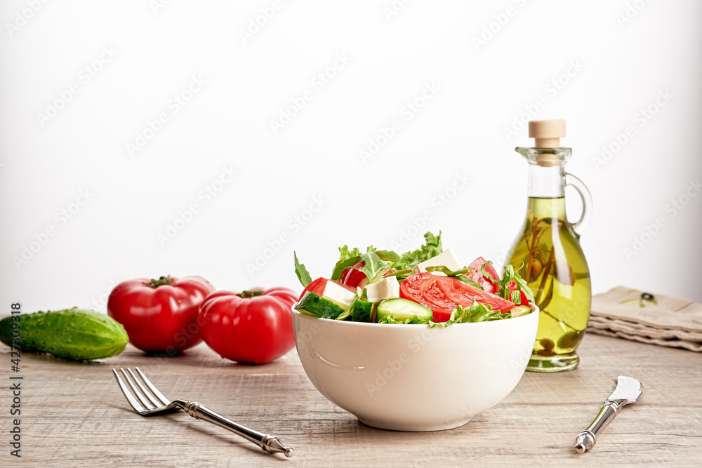 Healthy vegetable salad of fresh tomato, cucumber, onion, spinach, lettuce and sesame on plate. Diet menu Healthy vegetable salad of fresh tomato, cucumber, onion, spinach, lettuce and sesame on plate. Diet menu