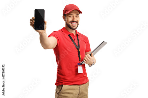 Slika na platnu Male worker in a red t-shirt showing a smartphone