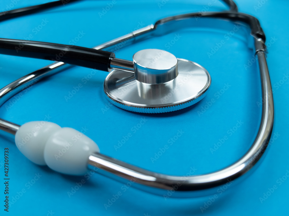 Black stethoscope on blue background. Stock photo. Black stethoscope on blue background. Stock photo.