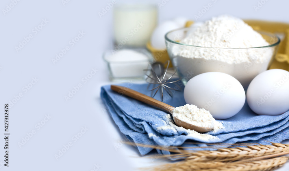 Baking products. Flour, eggs, milk and sugar on the table. Cooking process. Close-up. Copy space. Baking products. Flour, eggs, milk and sugar on the table. Cooking process. Close-up. Copy space.